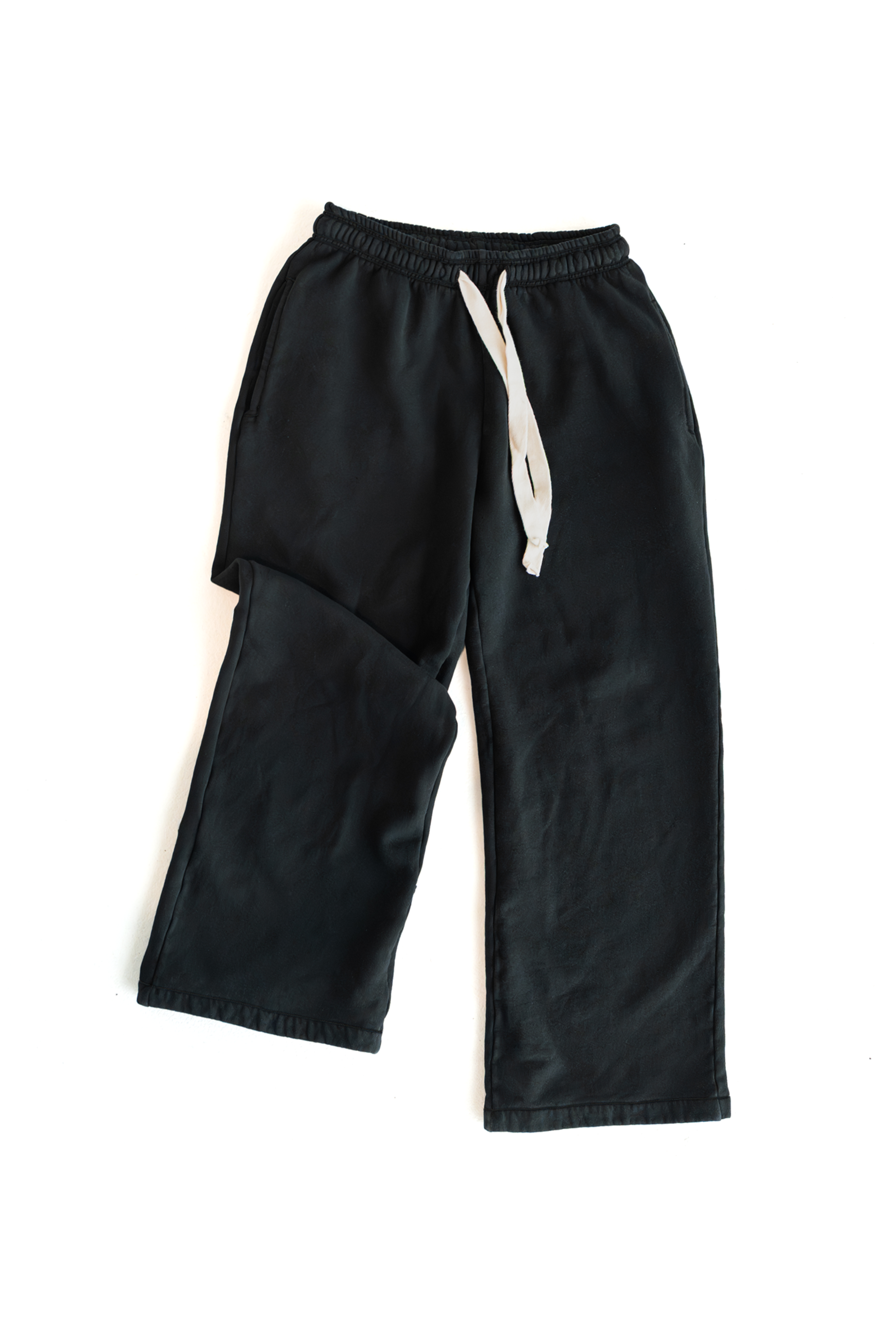 Black DISRPT signature heavyweight sweatpants with white drawstring on white background, minimalist design