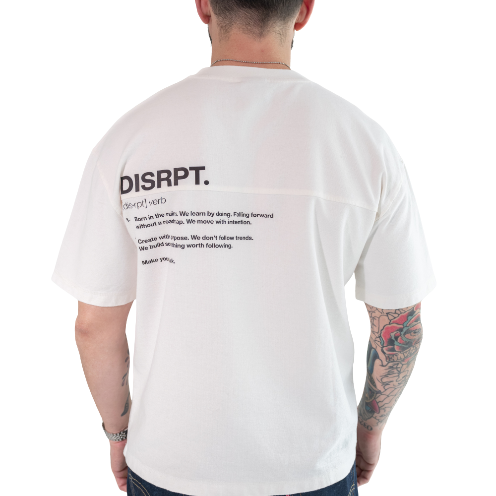 Person wearing white DISRPT No Permission Required box tee back view on white background with minimalist design and boxy fit