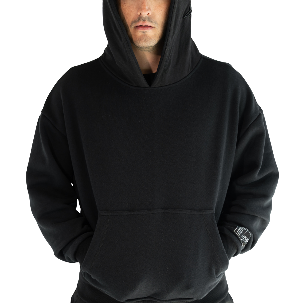 Person wearing black DISRPT signature heavyweight hoodie on white background with minimalist design