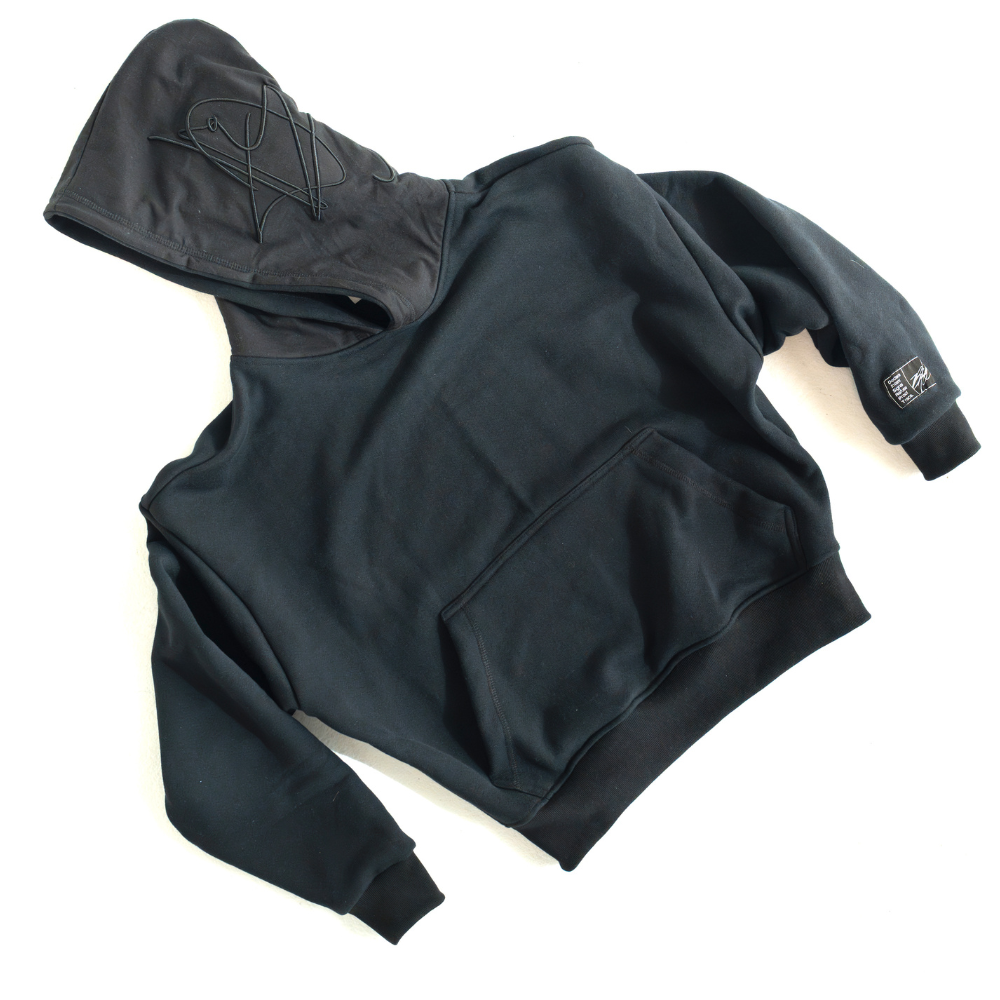 Black DISRPT signature heavyweight hoodie front view on white background with minimalist design and relaxed fit