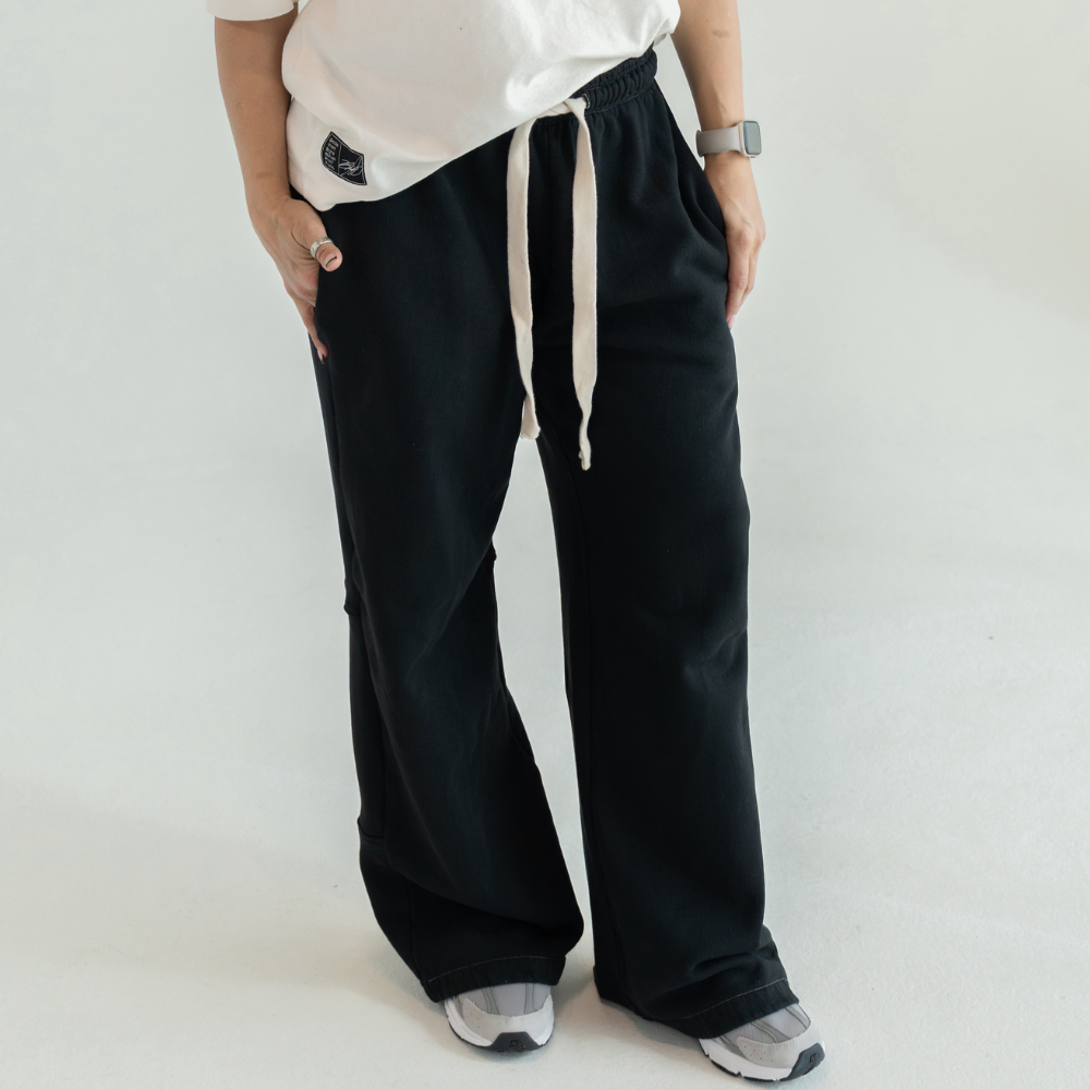 Black DISRPT signature heavyweight sweatpants front view on white background with minimalist design and relaxed fit