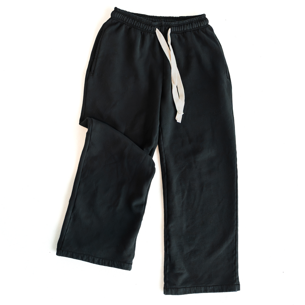 Black DISRPT signature heavyweight sweatpants with white drawstring on white background, minimalist design